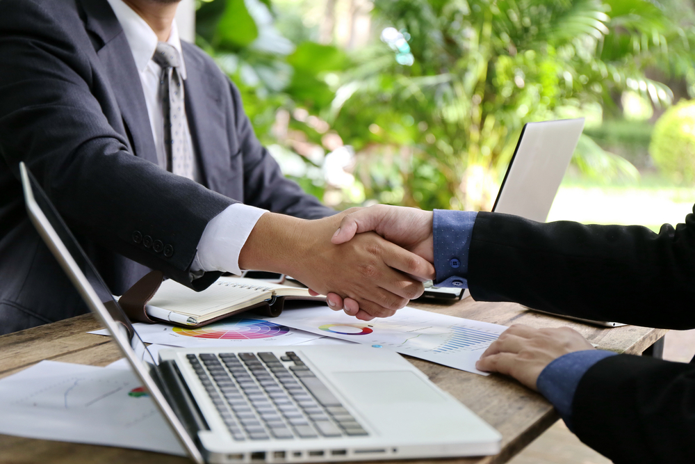 Shaking hands; Hiring manager working with a recruiter to hire the best construction candidate.